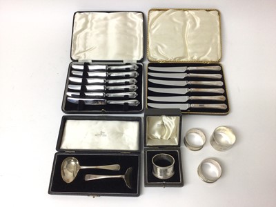 Lot 119 - Two sets of six silver-handled knives, together with a silver child's spoon and pusher, and four silver napkin rings