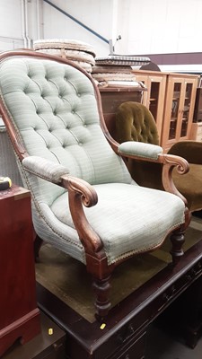 Lot 901 - Victorian button back armchair with green upholstery on turned front legs and castors