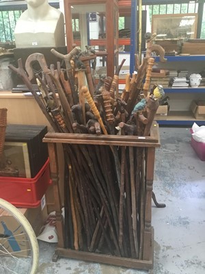 Lot 40 - Collection of novelty walking sticks and thumb sticks in wooden stand ( 50 plus )