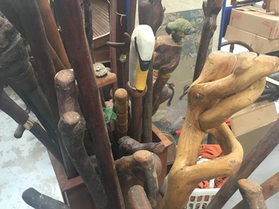 Lot 42 - Collection of novelty walking sticks and thumb sticks in two wooden stands - approx 40