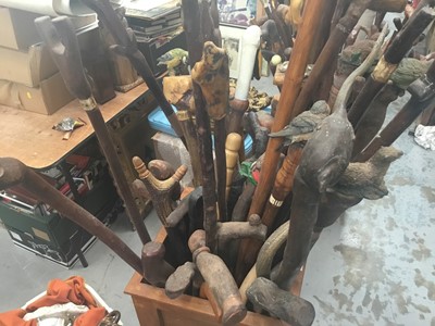 Lot 42 - Collection of novelty walking sticks and thumb sticks in two wooden stands - approx 40