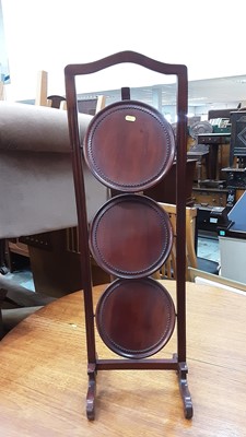 Lot 910 - Mahogany three tier folding cake stand, together with a walnut two tier plant stand