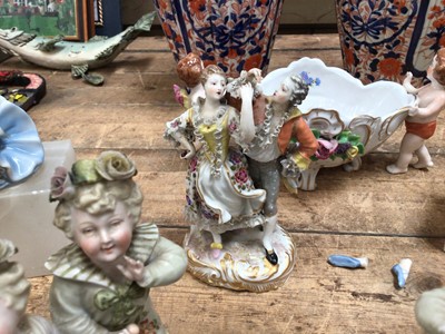 Lot 17 - Six pieces of continental porcelain, including a pair of figures on stone bases, a pair of figural groups, another group, and a bowl