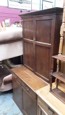 Lot 918 - Edwardian oak two height bookcase with adjustable shelves above enclosed by two panelled doors, two drawers and two panelled doors below, 99cm wide, 49cm deep, 194cm high