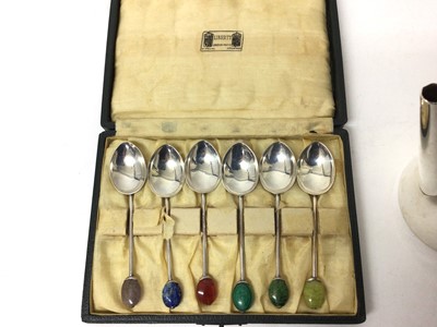 Lot 129 - Sterling silver cafe au lait pot with flying coffee bean thumb rest, together with a cased set of six silver coffee spoons with semi-precious coffee bean terminals, retailed by Liberty