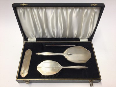 Lot 313 - 1960's silver backed hand mirror, brushes and comb set, with engine turned decoration, (Birmingham 1967), in fitted case