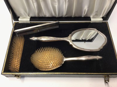 Lot 313 - 1960's silver backed hand mirror, brushes and comb set, with engine turned decoration, (Birmingham 1967), in fitted case