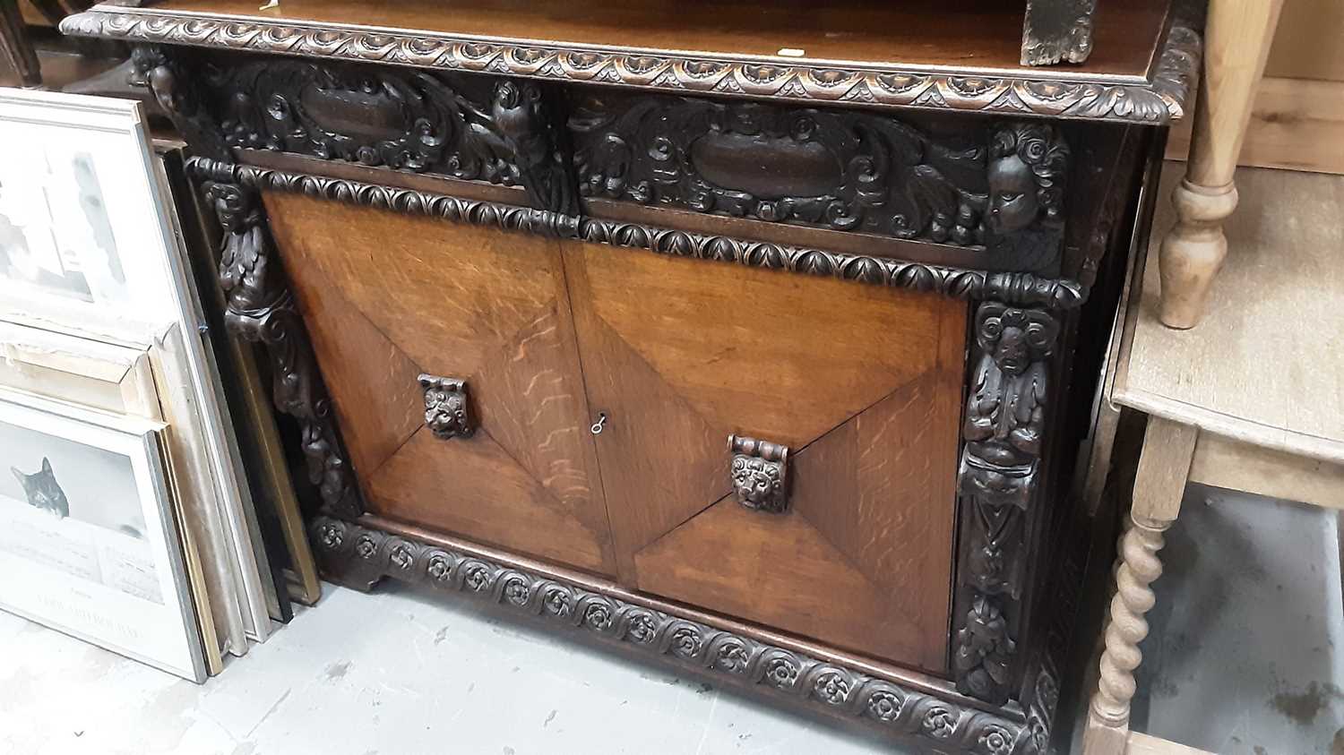 Lot 948 - Late Victorian carved oak sideboard with two frieze drawers and cupboards below with carved lions head handles, 132cm wide, 54.5cm deep, 105cm high