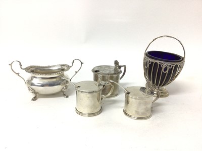 Lot 175 - Three silver mustards (two with spoons, one with liner missing), a silver sugar basket with liner, and a silver sugar bowl with paw feet