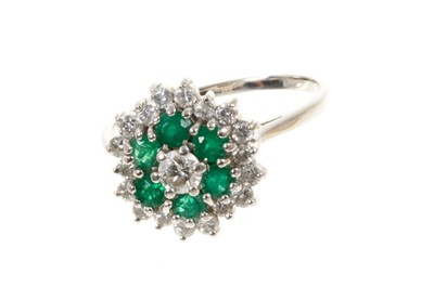 Lot 582 - Emerald and diamond cluster ring with a central brilliant cut diamond surrounded by emeralds and a further border of brilliant cut diamonds in claw setting on 18ct yellow gold shank