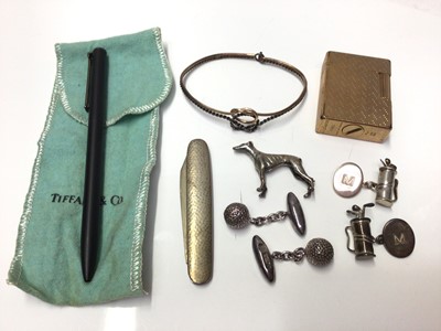 Lot 272 - Group to include silver greyhound, two pairs of novelty silver golfing cufflinks, Tiffany pen, silver and gold bangle, DuPont lighter, and a silver mounted penknife