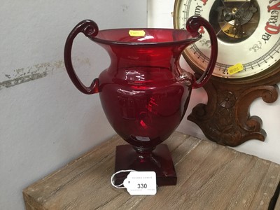 Lot 330 - Ruby glass two handled urn on square base.
