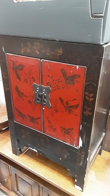 Lot 954 - Chinese lacquered cabinet decorated with butterflies together with a Chinese carved camphor wood blanket box (2)