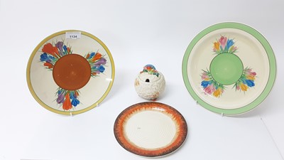 Lot 1025 - Three Clarice Cliff plates, together with a Celtic Harvest preserve pot (4)