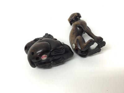 Lot 198 - Two wooden Japanese netsuke of animals - one a dog and the other a cat with a rat seated on him