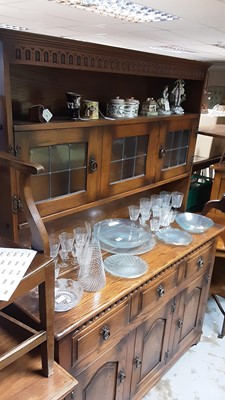 Lot 981 - Old Charm style oak two height dresser with leaded glazed doors above, three drawers and three panelled doors below, 131cm wide, 45cm deep, 182cm high