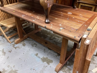 Lot 1039 - Teak extending rectangle garden table with nine folding chair