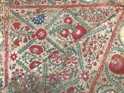 Lot 2081 - 19th century Suzani textile worked in panels and re-stitched together. Hand stitched silk thread embroidery over drawn pattern on linen foundation cloth. Traditional floral design.