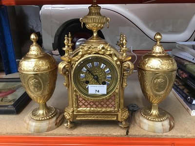 Lot 74 - DecorativeFrench gilt metal mantle clock , key and pendulum present and pair vases and covers