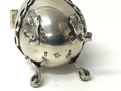 Lot 221 - Victorian silver mustard, liner and associated spoon, London 1862, of egg form with swag decoration and four paw-and-ball-feet, engraved crest to front, 9cm high