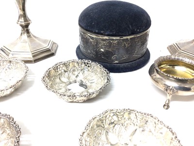 Lot 222 - Quantity of silver, including a pair of candlesticks, pin cushion, milk jug, a set of four embossed dishes, and a pair of George Unite tripod salts