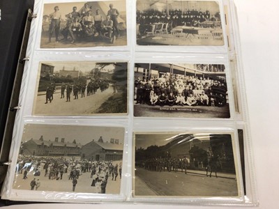 Lot 1400 - Postcards - An extensive collection in four albums.  Many early cards and real photographic cards including Military regiments, camps, parades, sports, Military Hospital, good animated street scene...