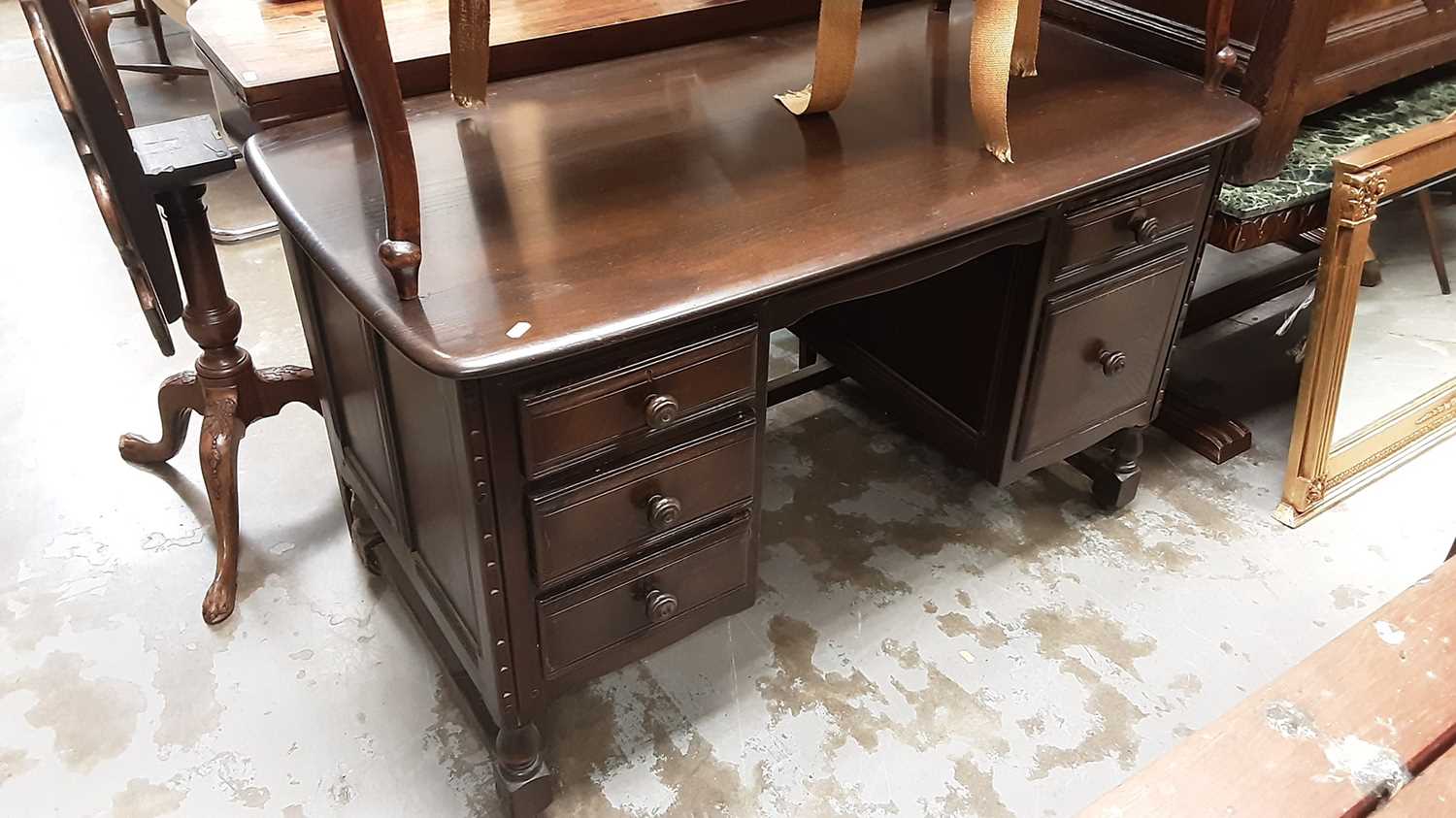 Lot 1007 - Ercol kneehole desk with five drawers, 121cm wide, 64cm deep, 72cm high