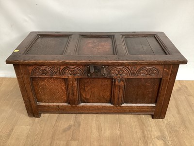 Lot 845 - 18th century carved oak coffer with panelled decoration on plank feet