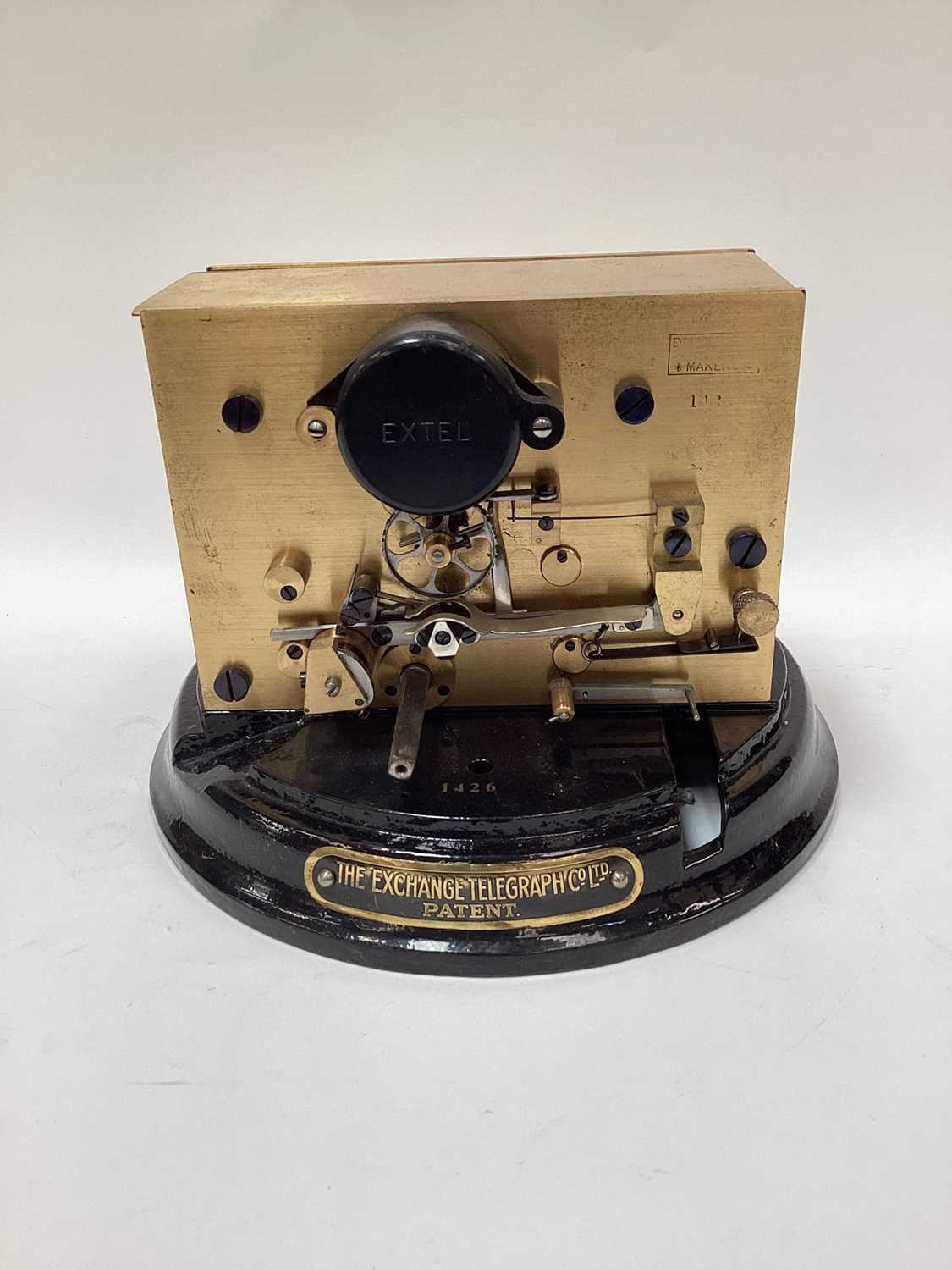 Lot 2443 - Rare early 20th century ticker tape machine by The Exchange Telegraph Co. Ltd. Number 1426, on circular cast metal black enamel base