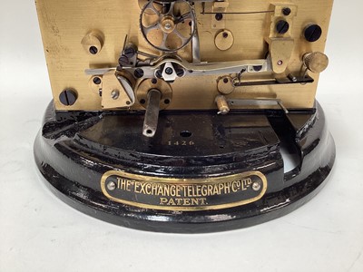 Lot 2443 - Rare early 20th century ticker tape machine by The Exchange Telegraph Co. Ltd. Number 1426, on circular cast metal black enamel base