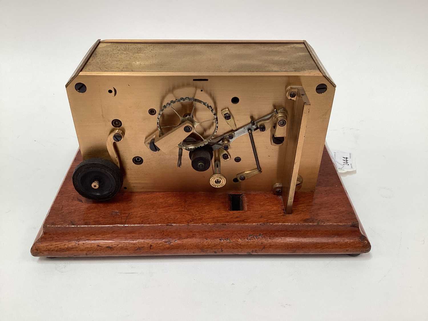 Lot 2444 - Rare early 20th century brass ticker tape machine on mahogany base