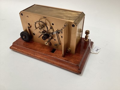 Lot 2444 - Rare early 20th century brass ticker tape machine on mahogany base