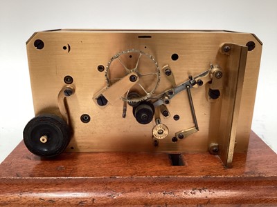 Lot 2444 - Rare early 20th century brass ticker tape machine on mahogany base