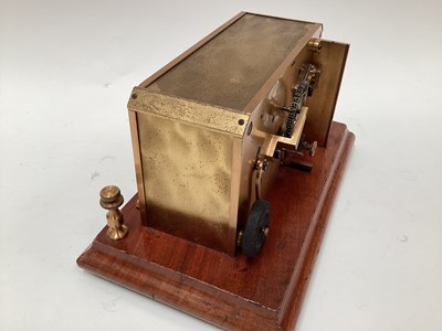 Lot 2444 - Rare early 20th century brass ticker tape machine on mahogany base