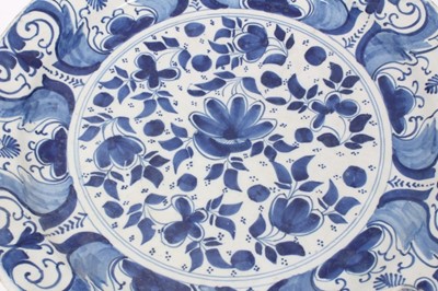 Lot 192 - Two 18th century Dutch Delft blue and white circular dishes with foliate panels, 34cm and 35cm diameter