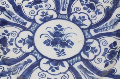 Lot 192 - Two 18th century Dutch Delft blue and white circular dishes with foliate panels, 34cm and 35cm diameter