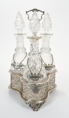 Lot 345 - Victorian silver decanter stand containing three cut glass decanters with silver labels