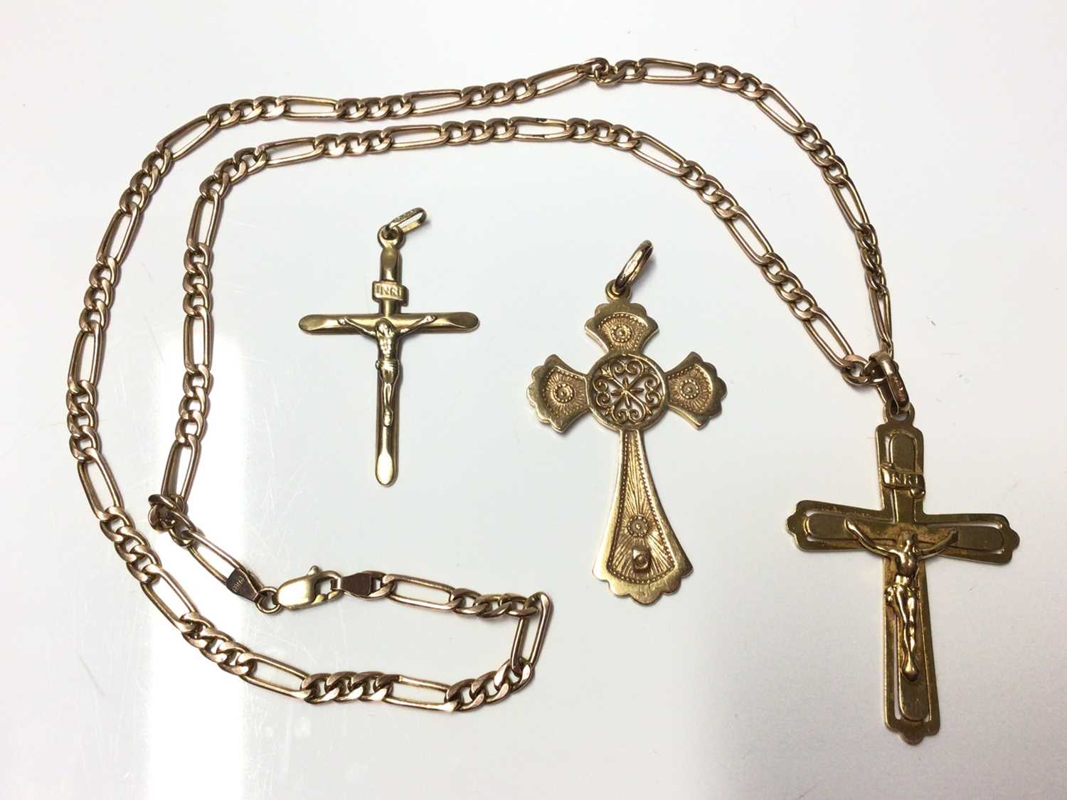 Lot 11 - 9ct gold link chain and three 9ct gold cross/crucifix pendants
