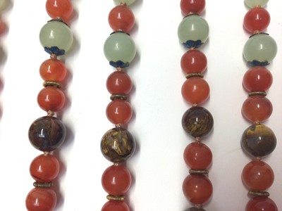 Lot 38 - Five Chinese green hard stone and carnelian polished bead necklaces