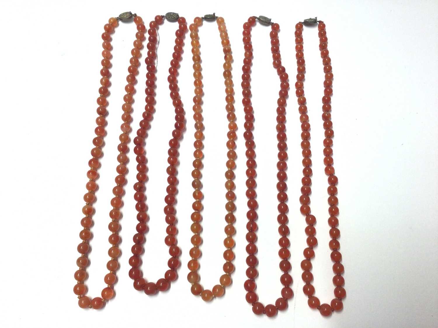 Lot 39 - Five Chinese carnelian polished bead necklaces