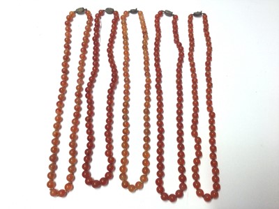 Lot 39 - Five Chinese carnelian polished bead necklaces