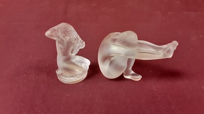 Lot 1016 - Lalique Floreal glass figure of a kneeling nude female, 8cm high, together with another Lalique glass nude female figure, both signed Lalique France (2)