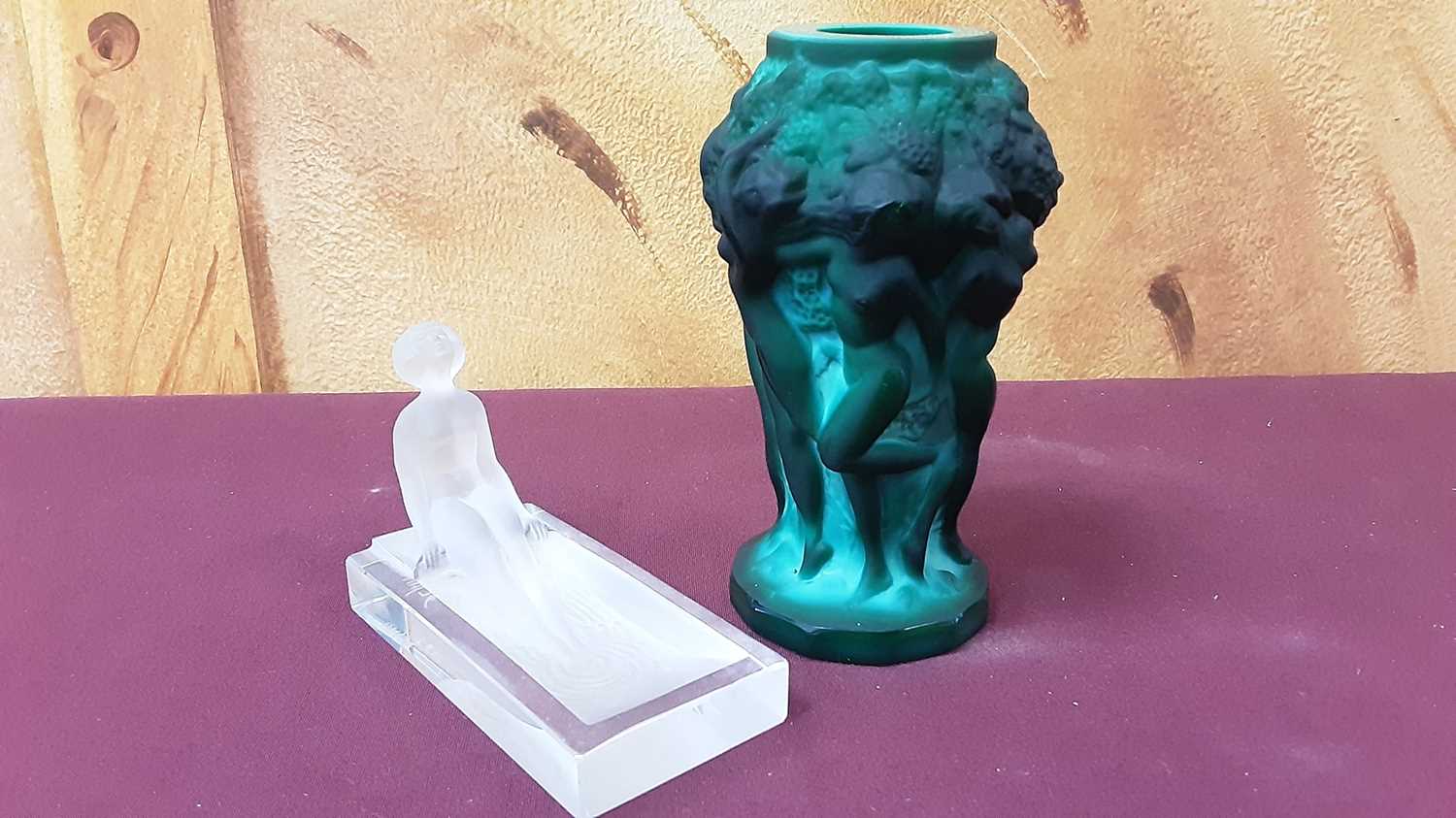 Lot 1018 - Art Deco style Czech Desna green glass vase with relief moulded decoration depicting dancing nude female figures,  12.5cm high, together with another Desna glass figure of a lady bathing, 6cm high,...