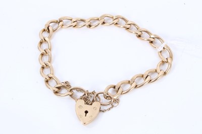 Lot 556 - 9ct gold curb link bracelet with padlock clasp