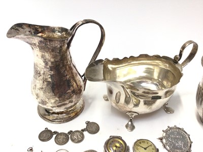 Lot 148 - Silver sauce boat, Arts & Crafts white metal milk jug, two silver cased watches, silver mounted coin brooch, other coins and plated items