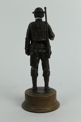 Lot 770 - Contemporary bronzed resin figure of a First World War Tommy, mounted on circular wooden base, 24cm in overall height.