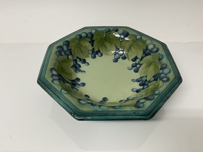 Lot 1041 - Moorcroft pottery octagonal bowl decorated in the leaves and berries pattern on blue and green ground, impressed marks and blue painted signature to base, 25.5cm