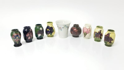 Lot 1044 - Eight Moorcroft miniature vases, various patterns, together with a Moorcroft Macintyre vase