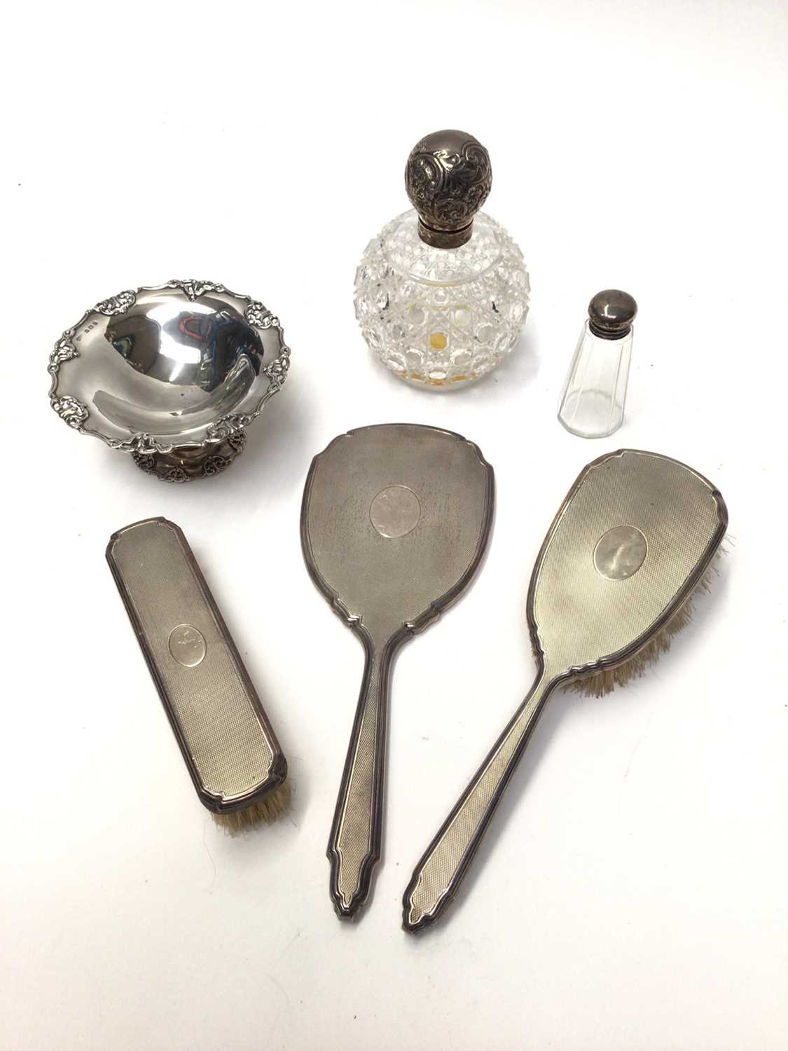 Lot 98 - Silver pedestal dish, silver backed three piece dressing table set and two silver topped glass bottles