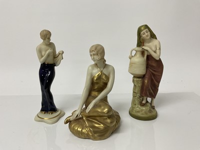 Lot 1075 - Three Royal Dux figures - lady in gold dress, lady with large pot and semi clad lady, all with pink triangle mark to base